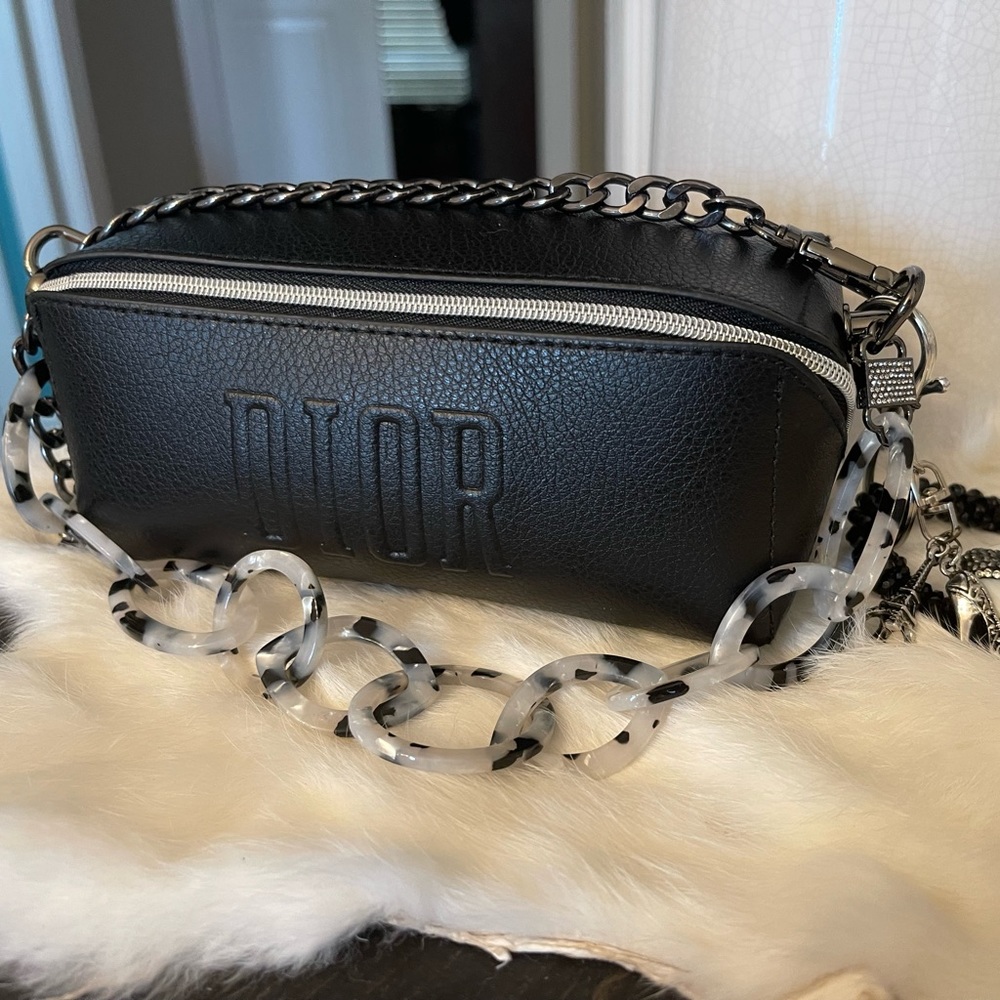 Dior black shoulder or hand bag with decorative keychain.